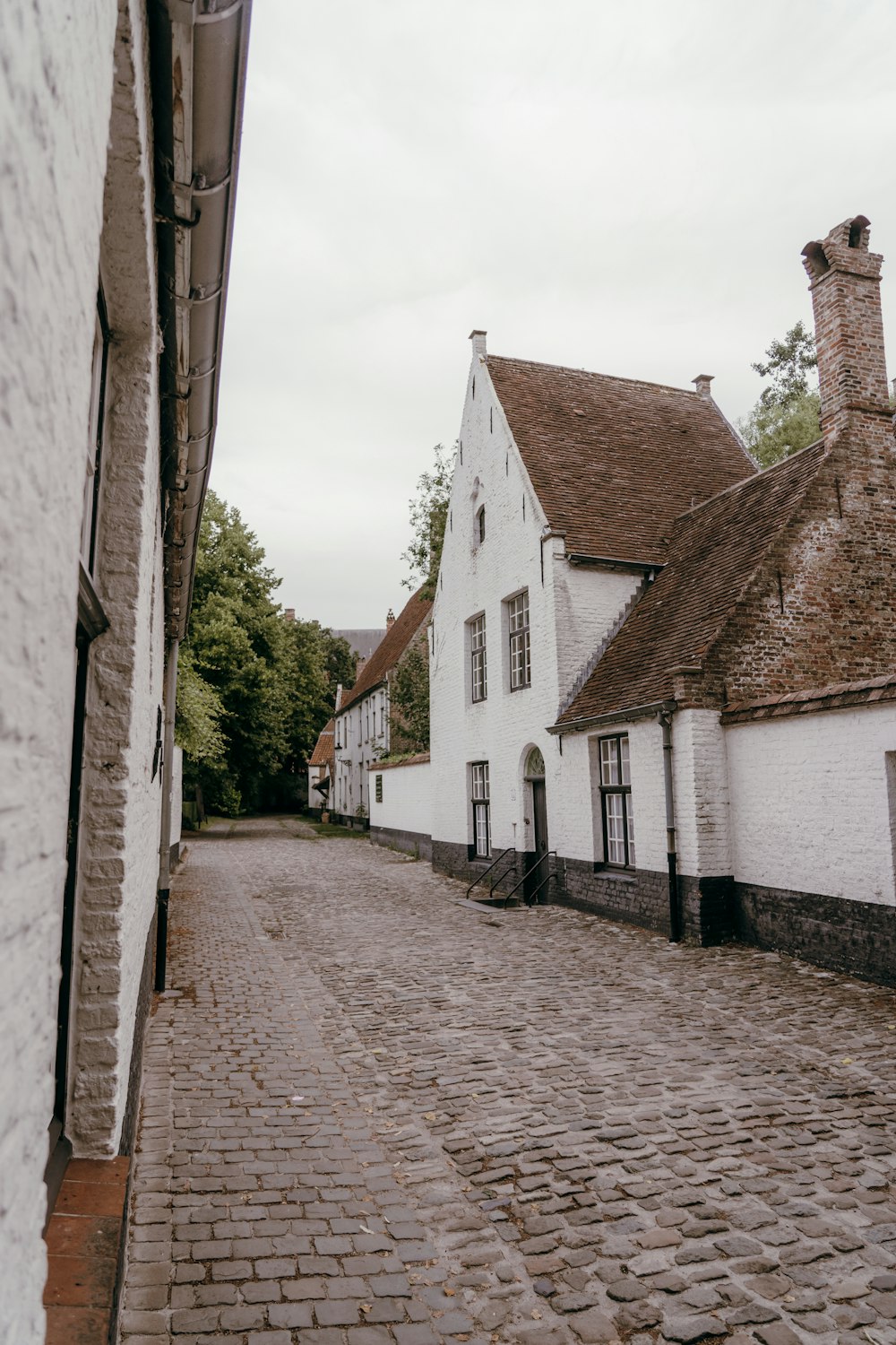 a cobblestone street between buildings