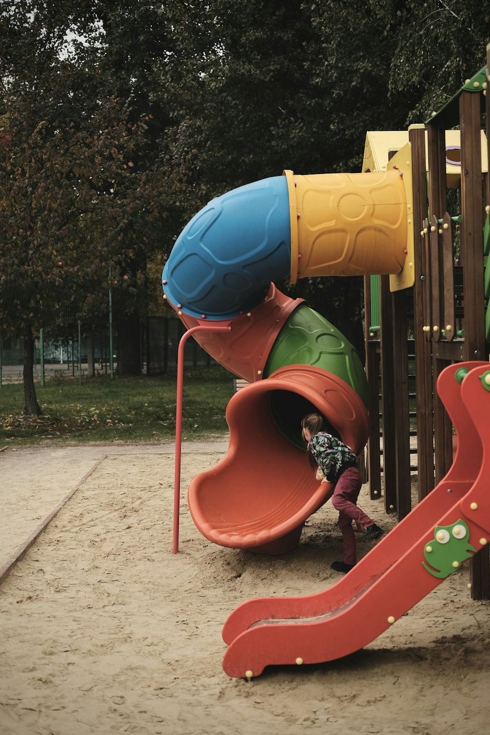 a child playing on a playground slide