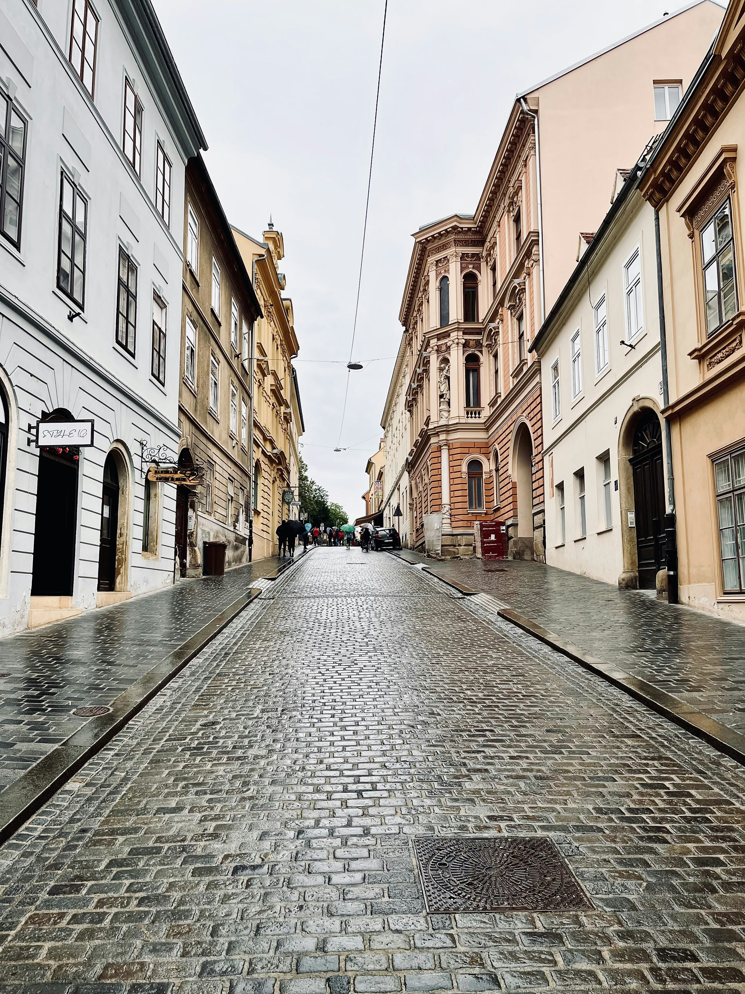 a cobblestone street between buildings