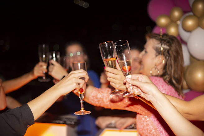 a group of people holding glasses of wine