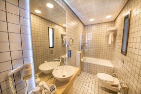 a bathroom with a tub sink and toilet