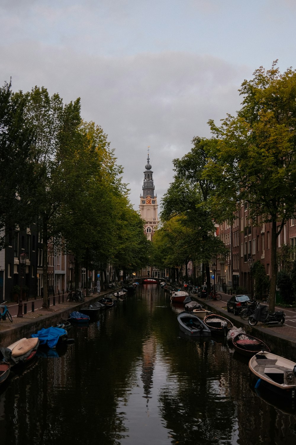 a river with boats on it and trees on the side