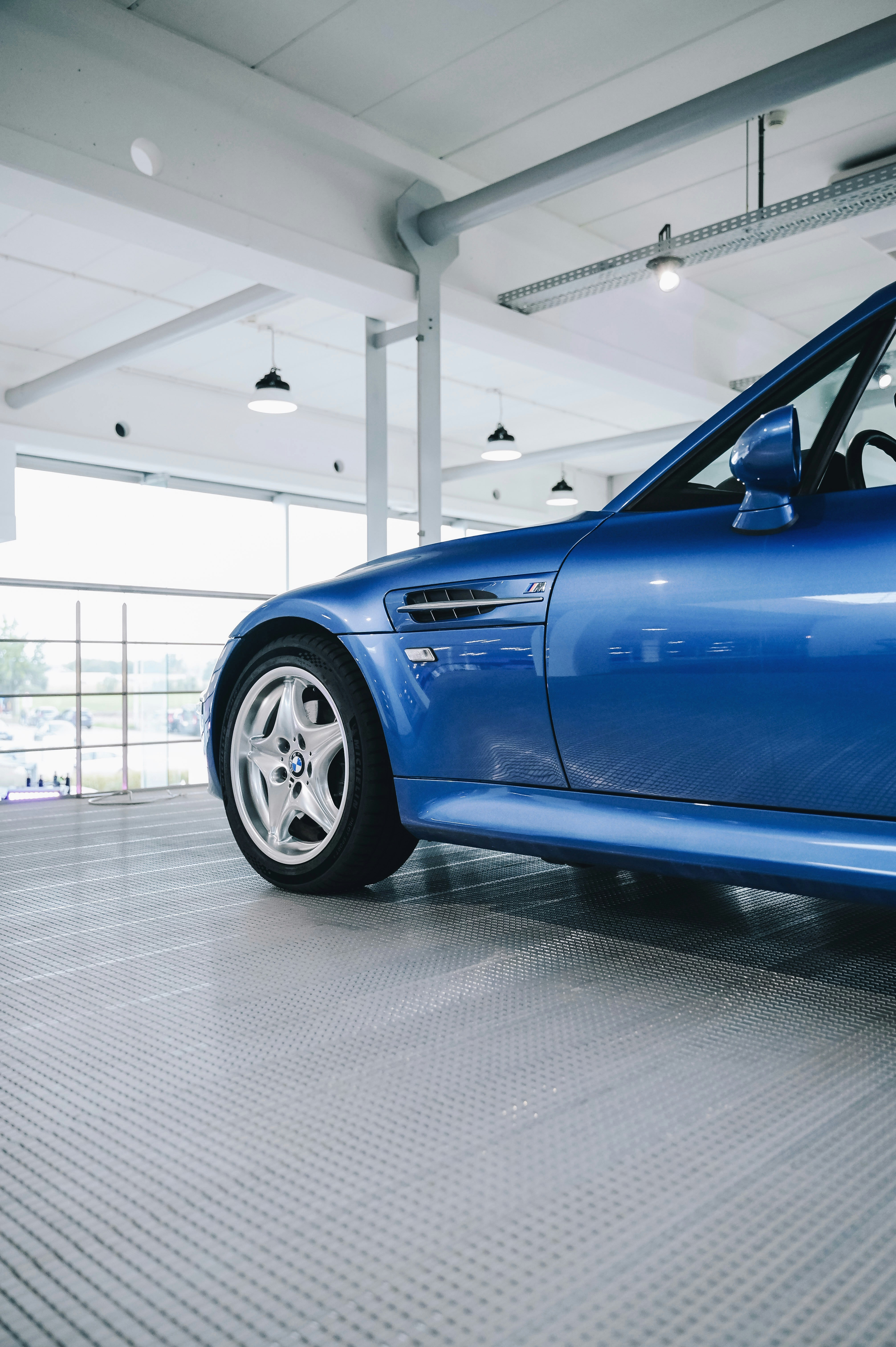 a blue car parked inside a building