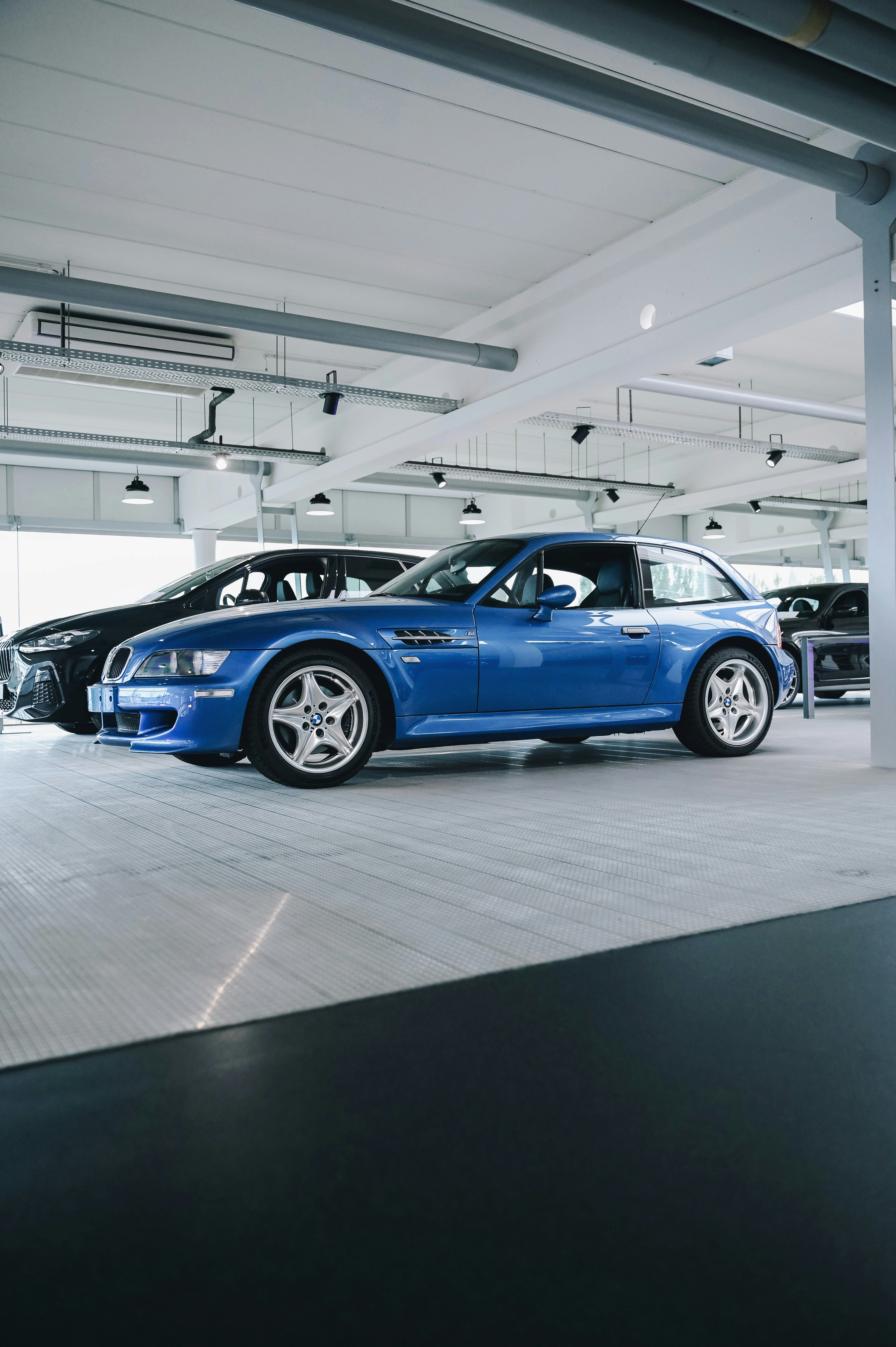 a blue car parked in a showroom