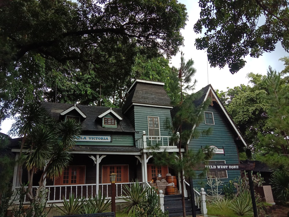 a green house with trees around it