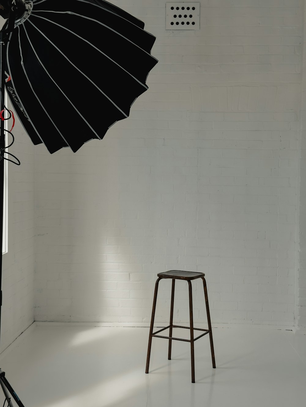 a stool and umbrella