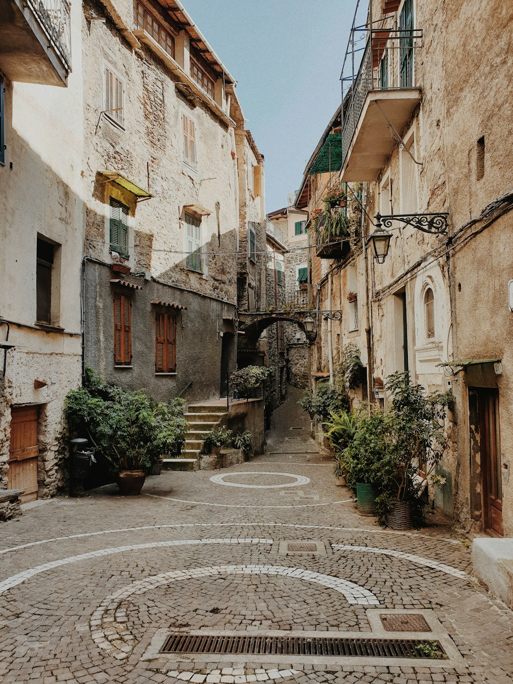 a cobblestone street with buildings on both sides