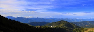 A panoramic view of the distant mountains framing the Wild & Woods Corbett property under a bright blue sky.