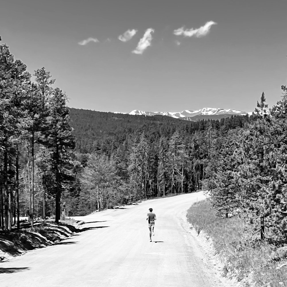 a person riding a bicycle on a snowy road