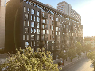 Modern residential building exterior in an urban neighborhood at sunset