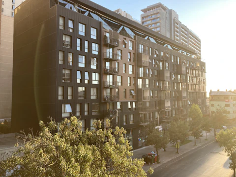 Modern residential building exterior in an urban neighborhood at sunset