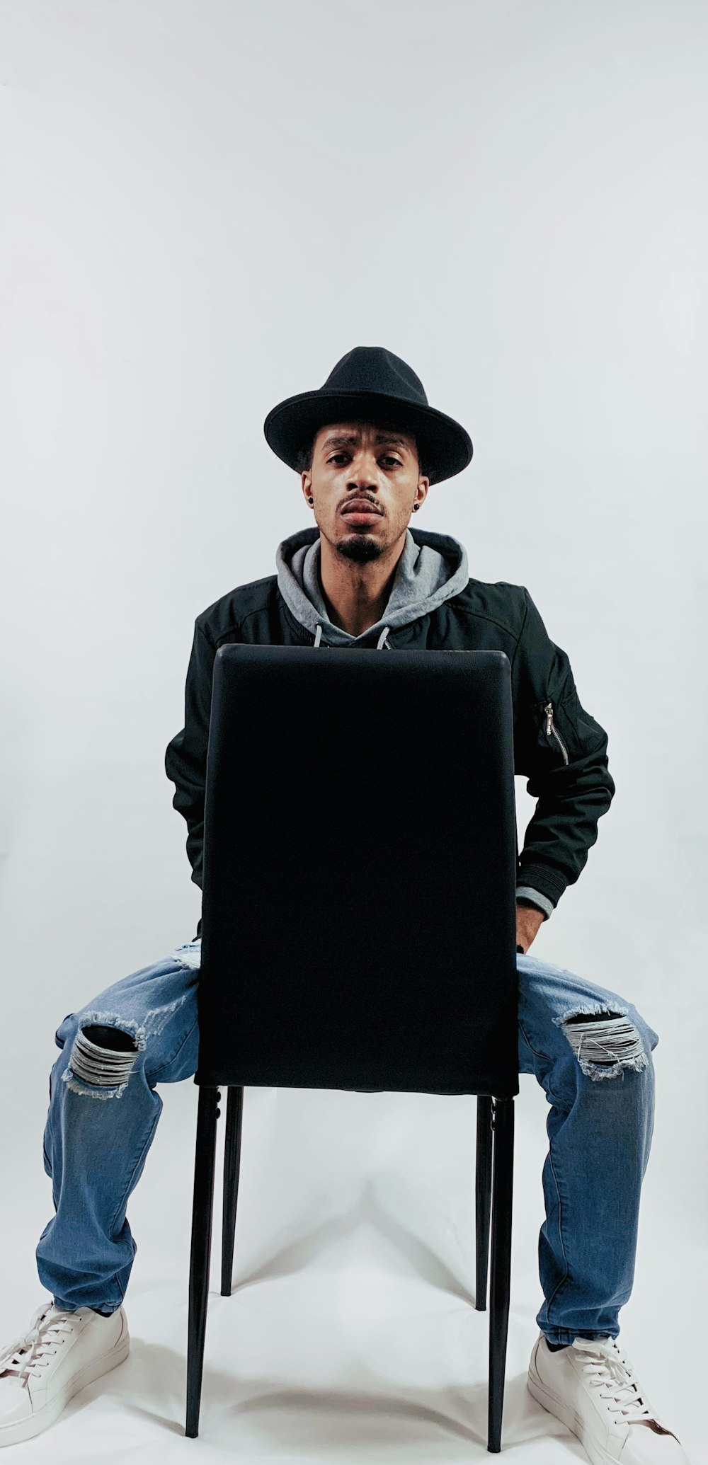 a man sitting in a chair with a laptop on his lap