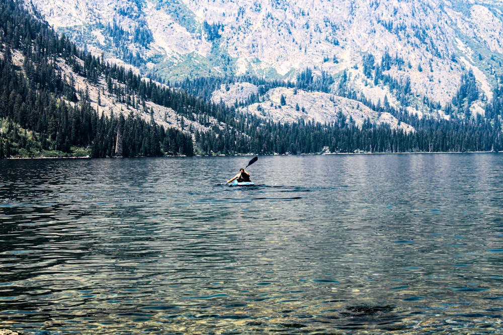 a person on a surfboard in a lake