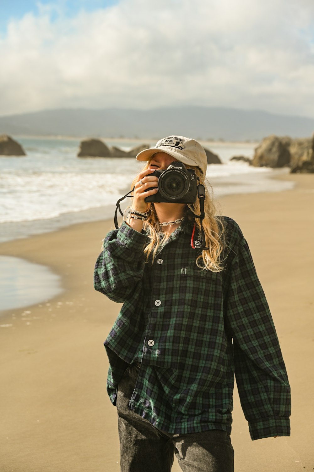 a person taking a picture of the ocean