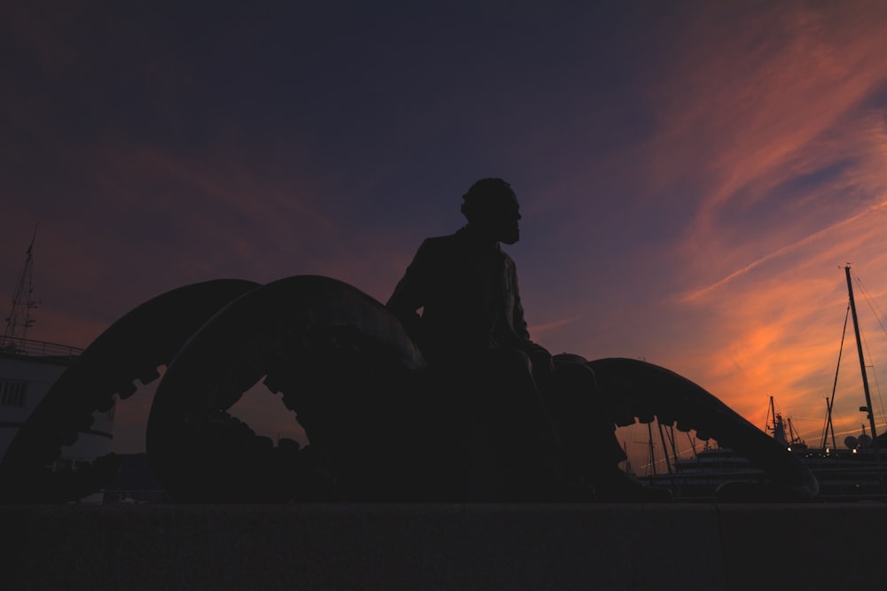 a person sitting on a statue