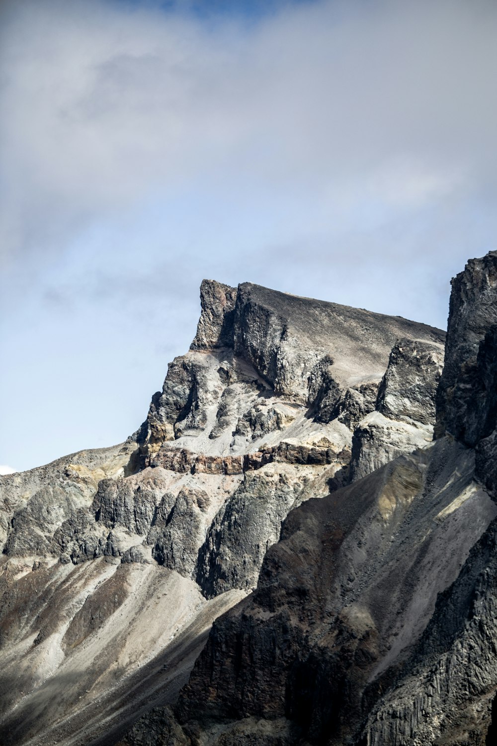 a rocky mountain with a blue sky