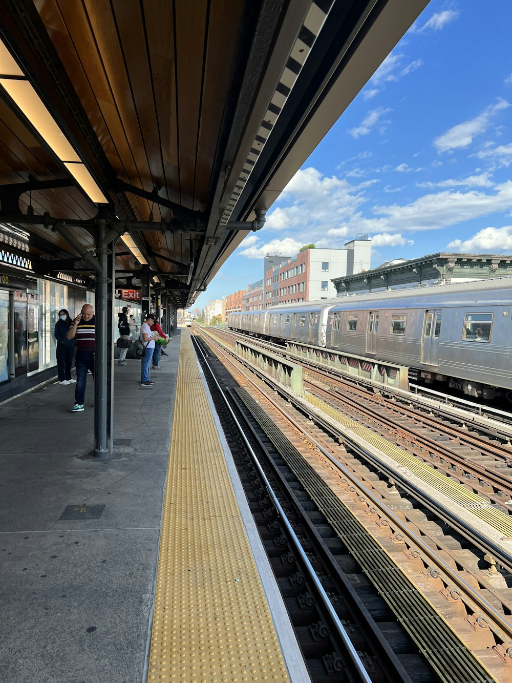 a train station with people waiting