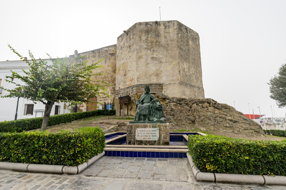 a statue in front of a building