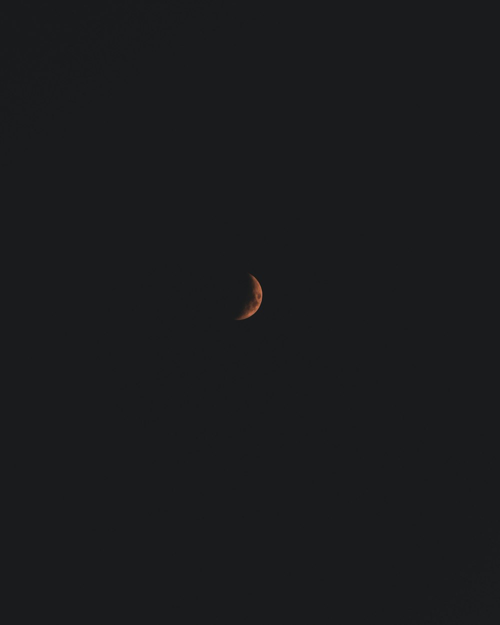 a crescent moon in a black sky