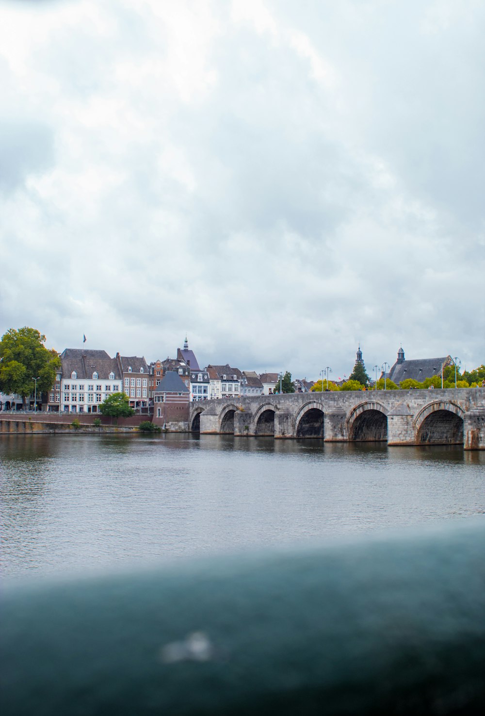 a bridge over a river with buildings on the other side