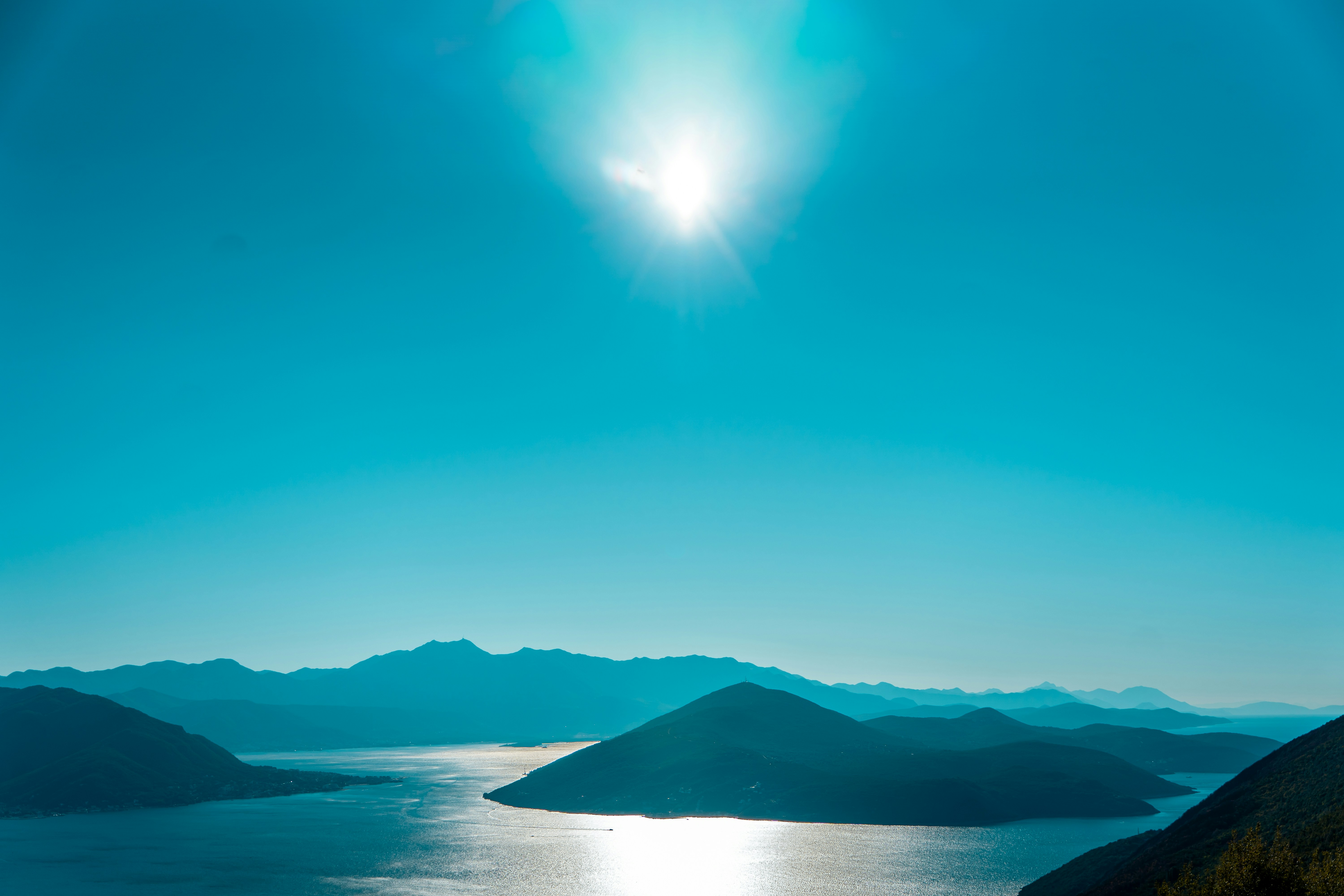a body of water with mountains in the background