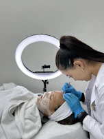 Close-up of a client receiving gentle facial care from an expert esthetician.