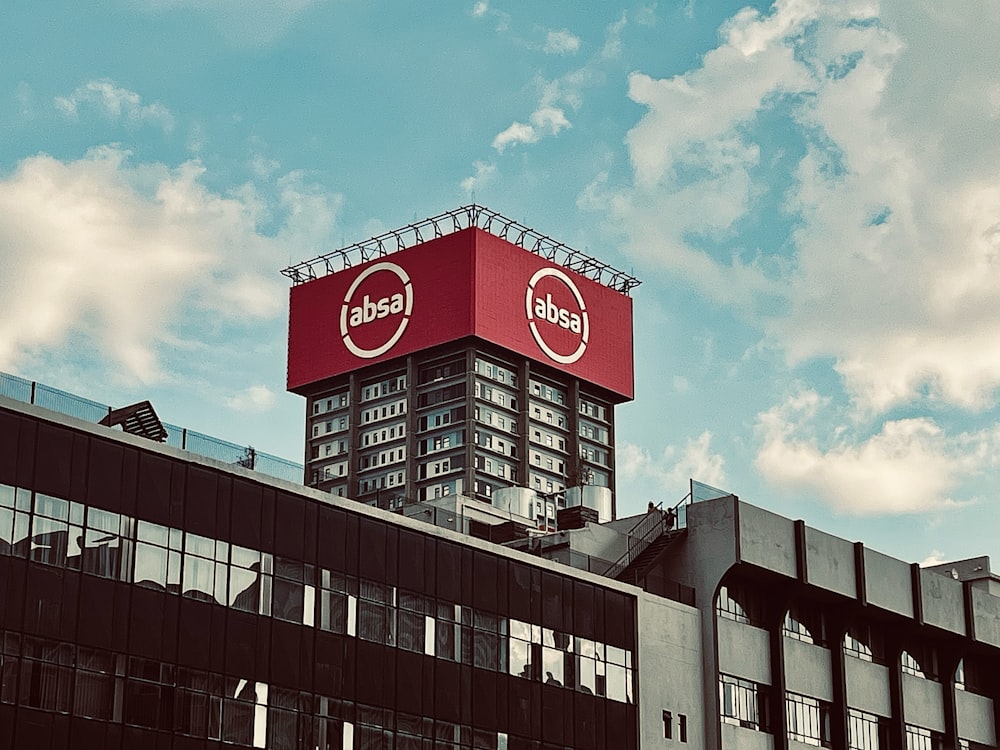 a large red sign on top of a building