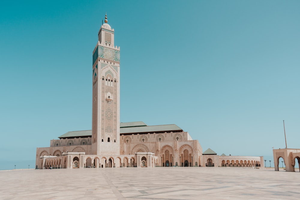a large building with a tall tower with Hassan II Mosque in the background