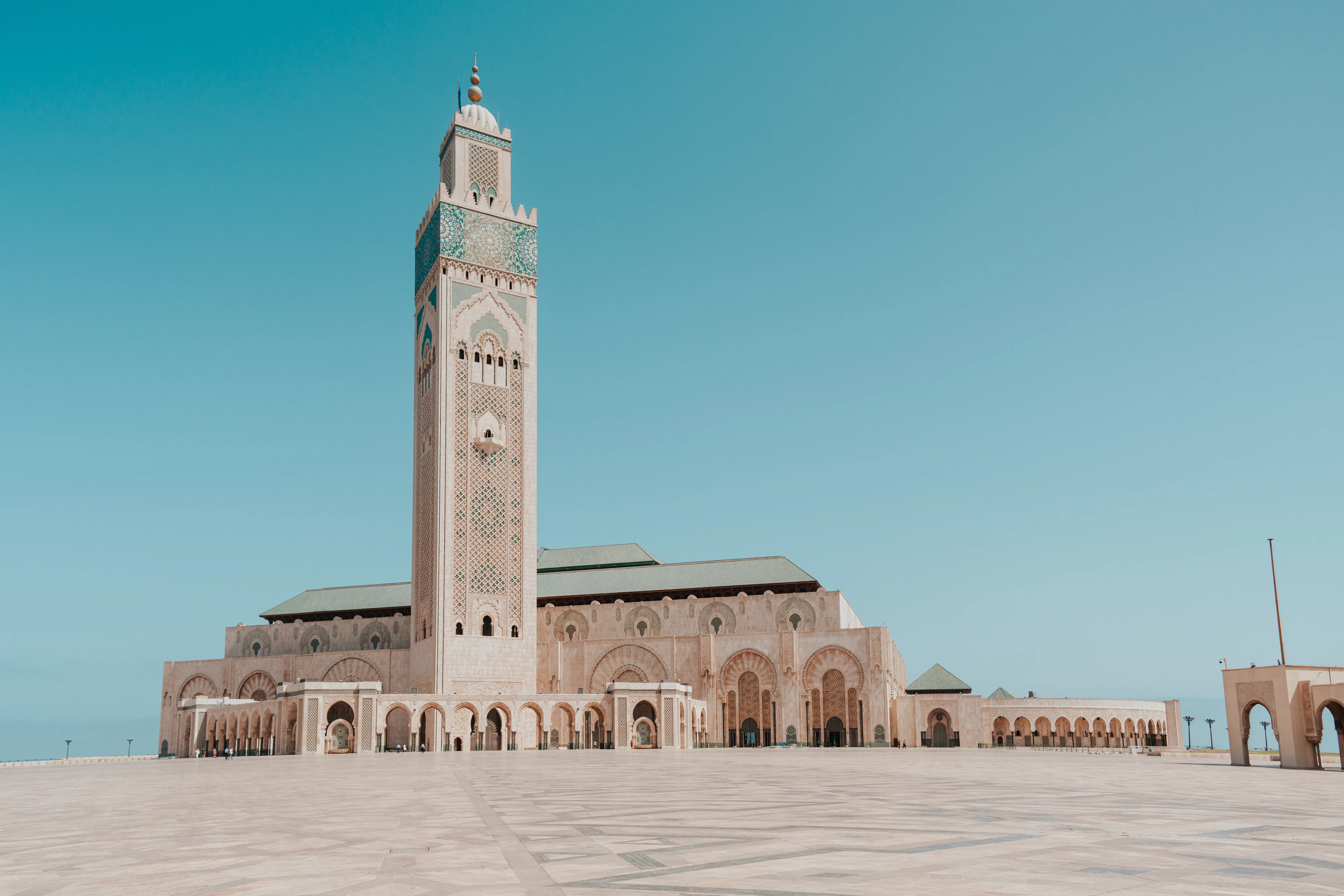 The minaret of the Hassan II Mosque in Casablanca rising over its arcaded terrace above the Atlantic