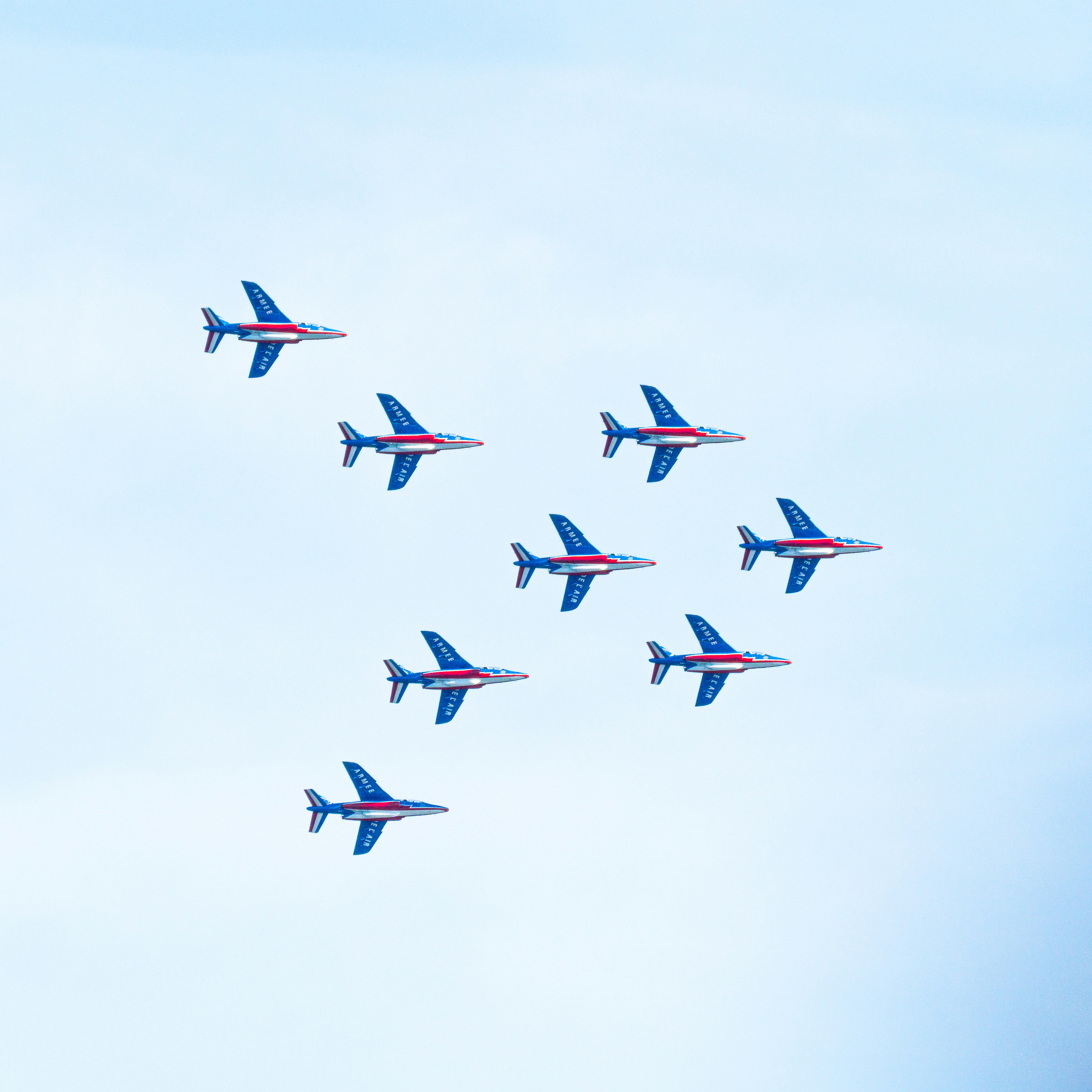 a group of blue airplanes flying in the sky