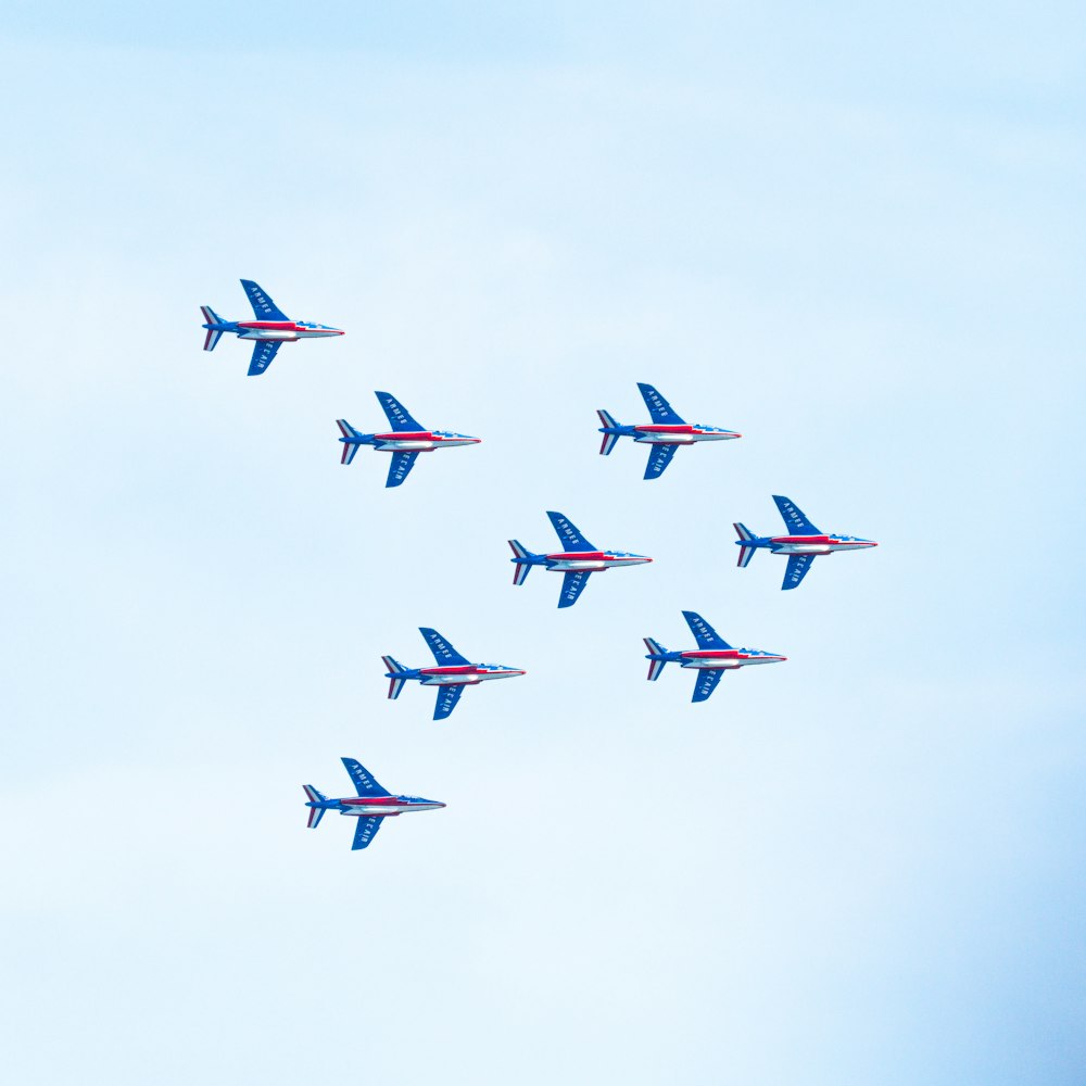 a group of blue airplanes flying in the sky