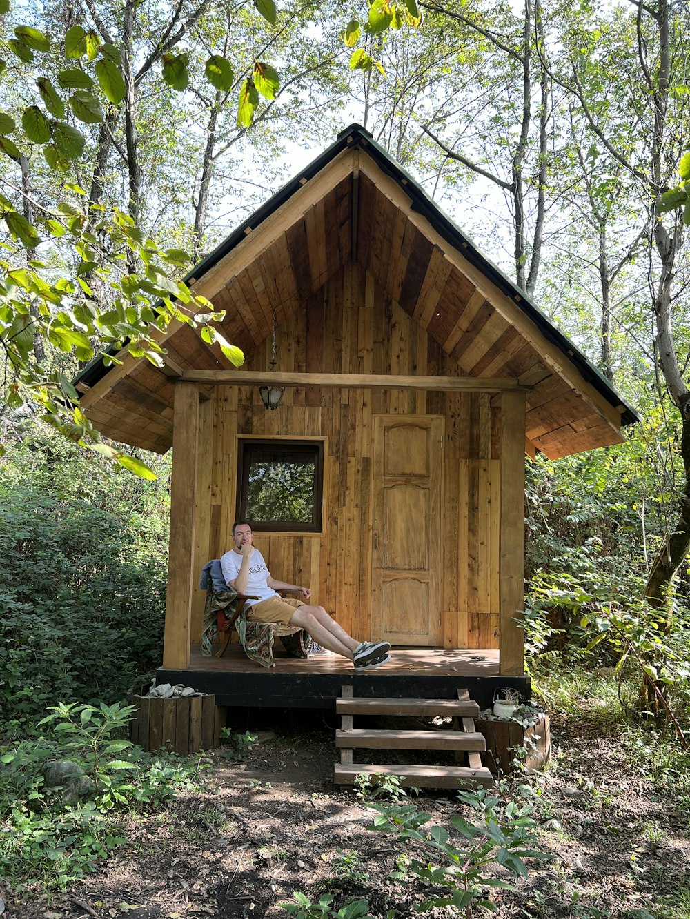 a person sitting in a small wooden house