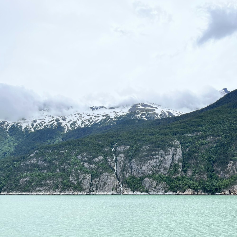 a body of water with mountains in the back