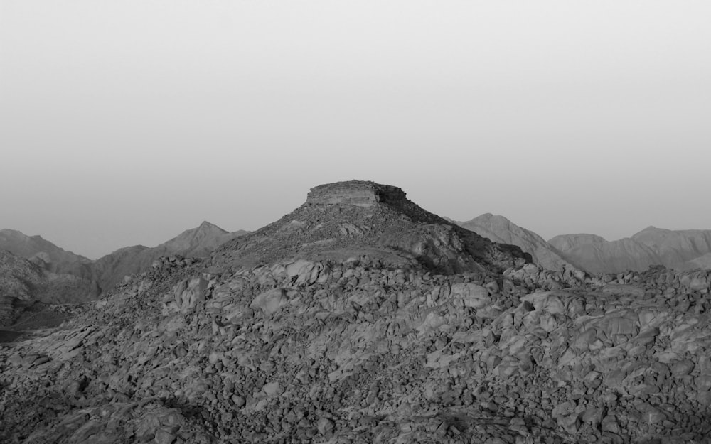 a rocky mountain with fog