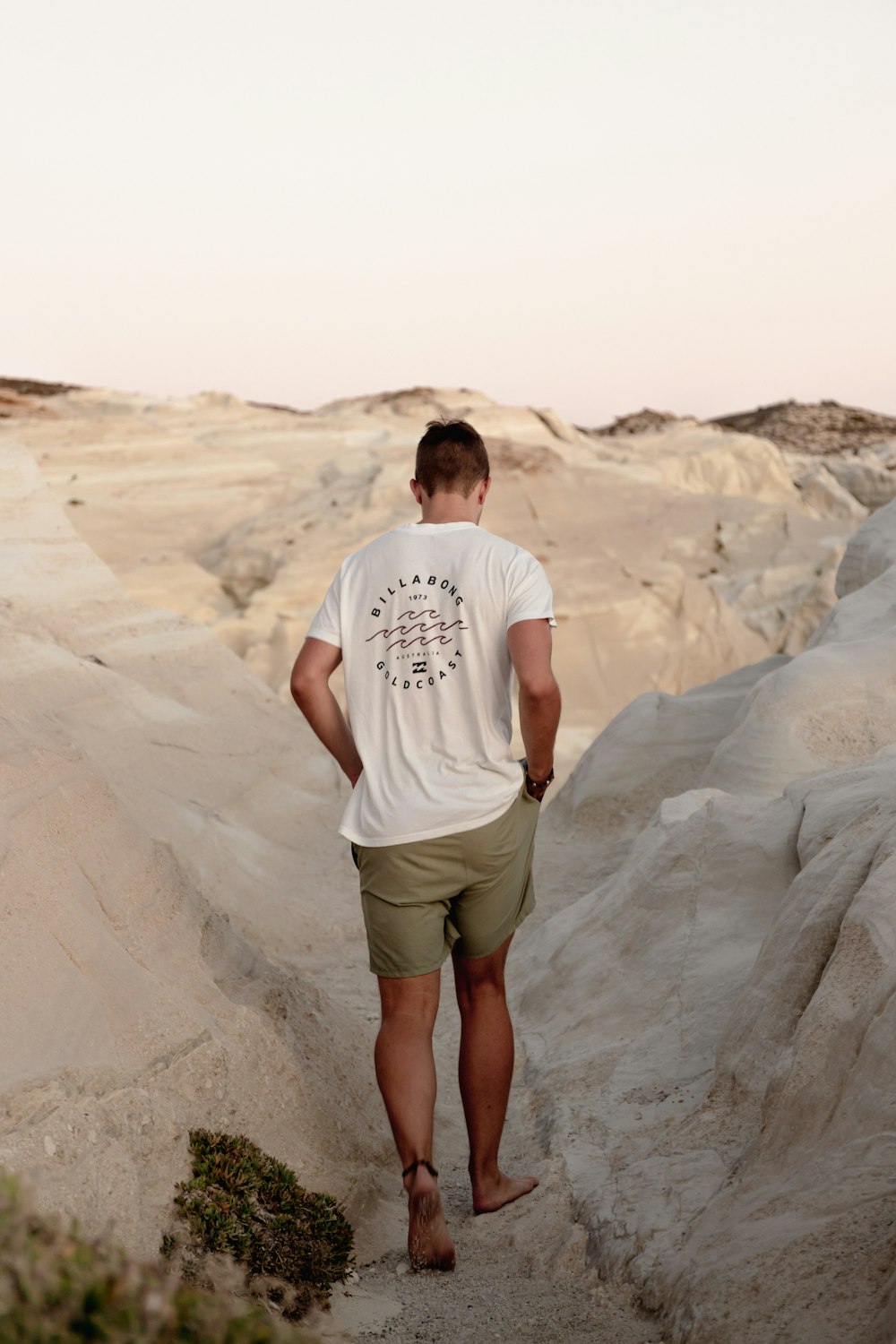 a man standing on a rocky hill