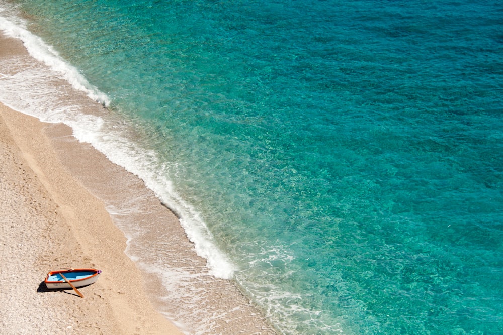 a beach with a chair and umbrella