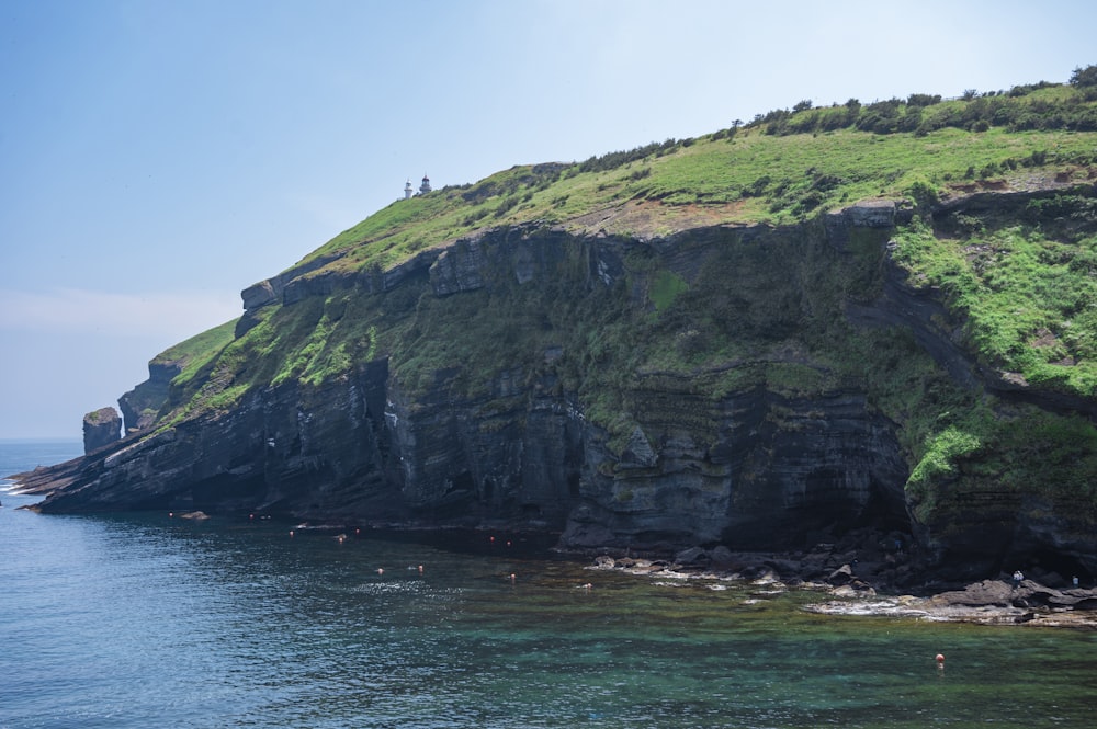 a cliff with a body of water below