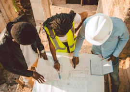 a group of people writing on a piece of paper