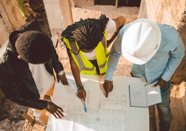 a group of people writing on a piece of paper