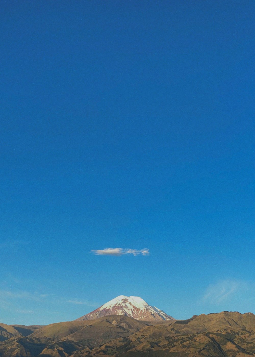 a mountain with a blue sky