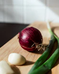 a red vegetable on a wooden surface