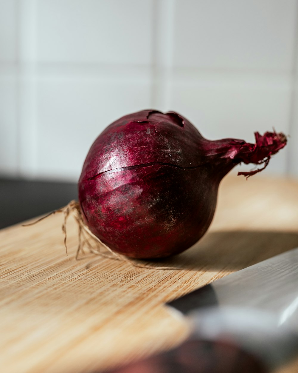 a red onion on a wooden surface