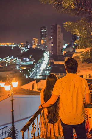Guests enjoying a relaxing evening on the balcony overlooking the city lights.
