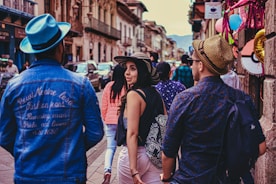 a group of people walking down a busy street