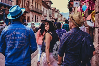 a group of people walking down a busy street