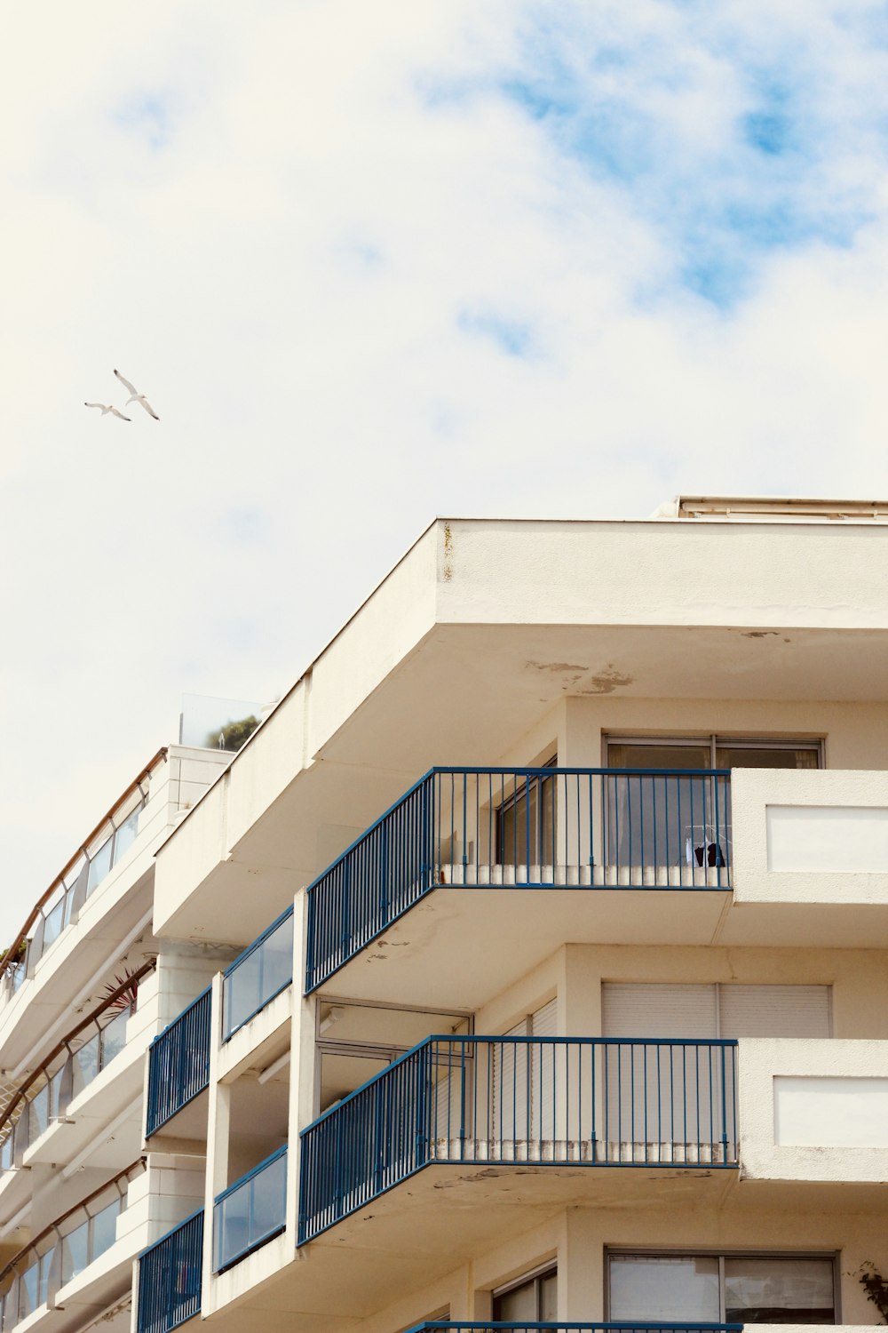 a building with balconies and a blue sky