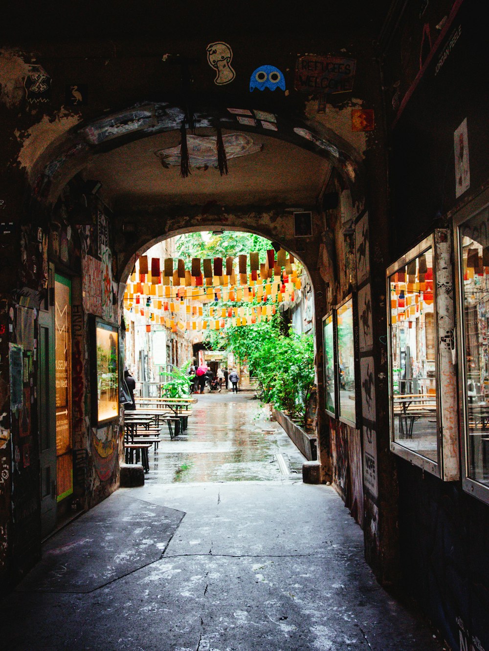 a walkway with people and shops