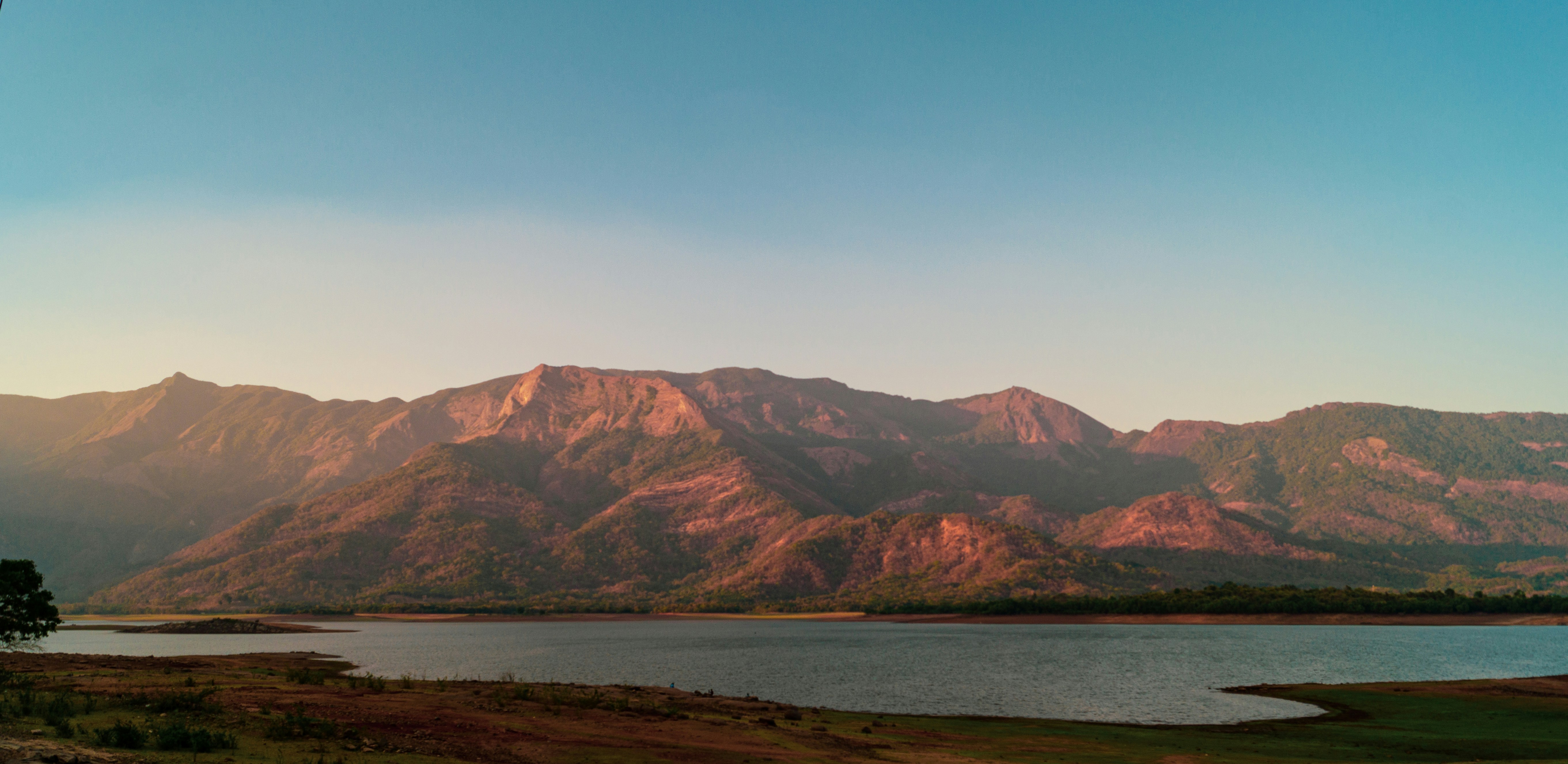 a body of water with mountains in the background
