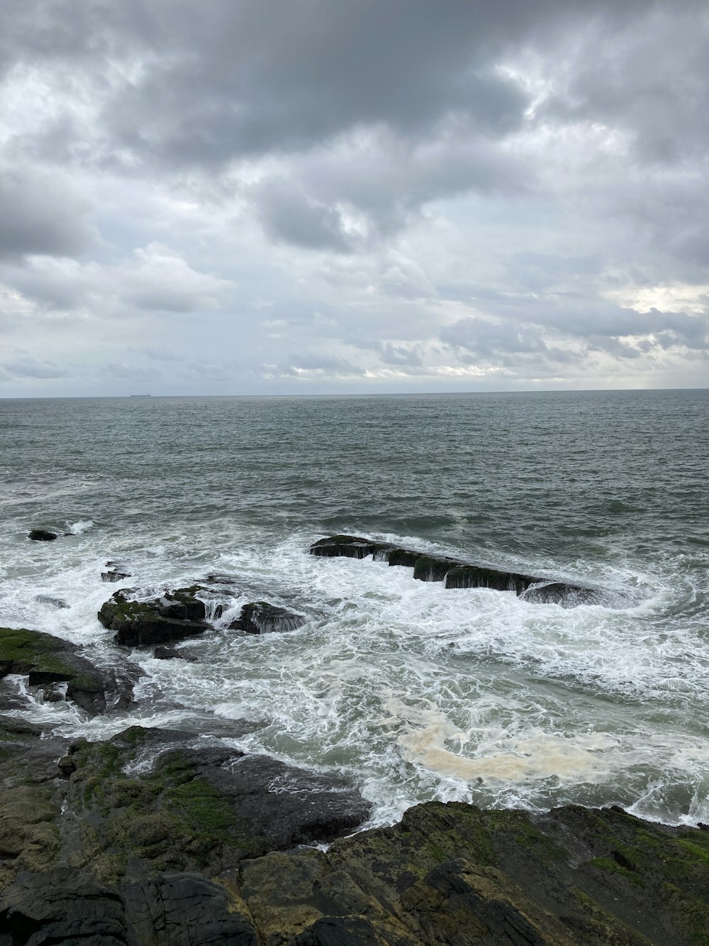 a rocky beach with waves crashing