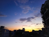 A vibrant city skyline at dusk with blue hues echoing drb's brand colors.